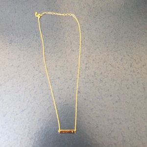 Gold bar necklace with clear gem